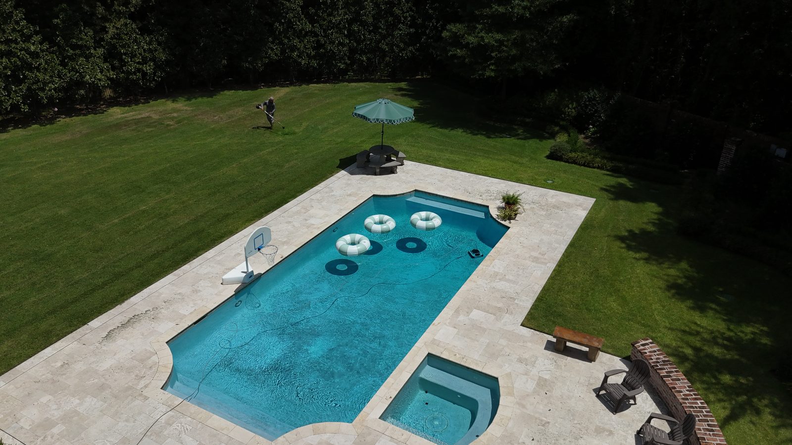 Aerial view of a manicured lawn and outdoor living area